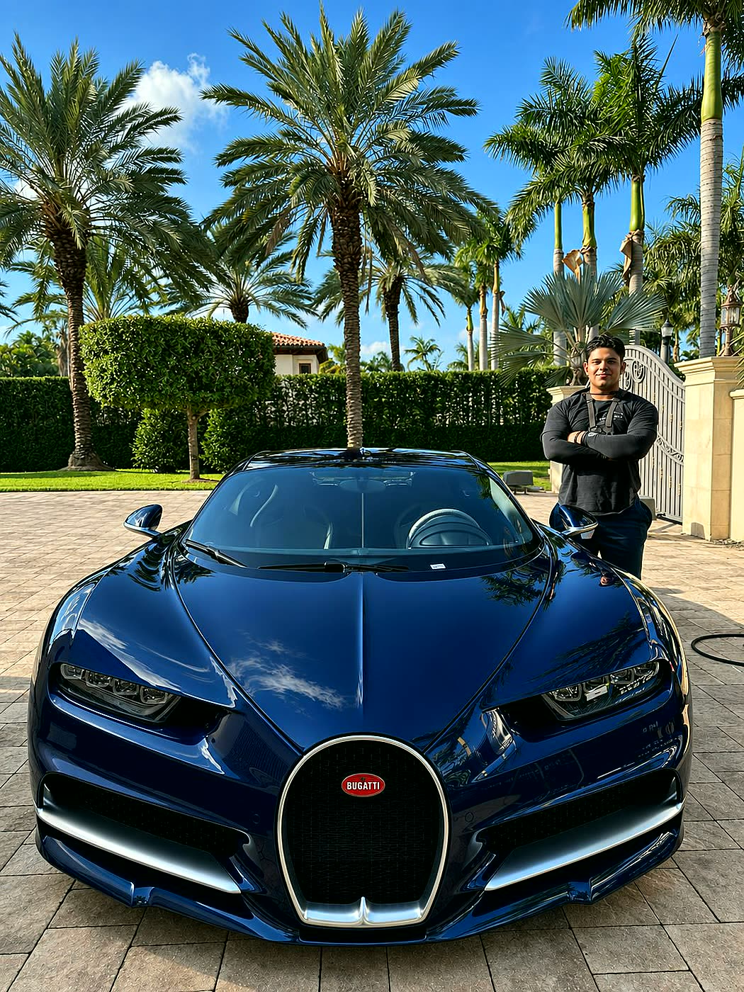 Technician performing a full mobile car detail on a blue sports car in Miami